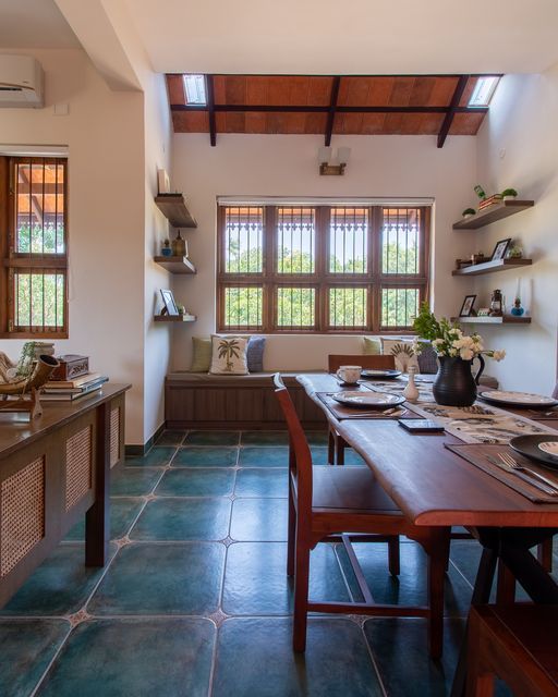 a dining room and kitchen area with blue tile flooring