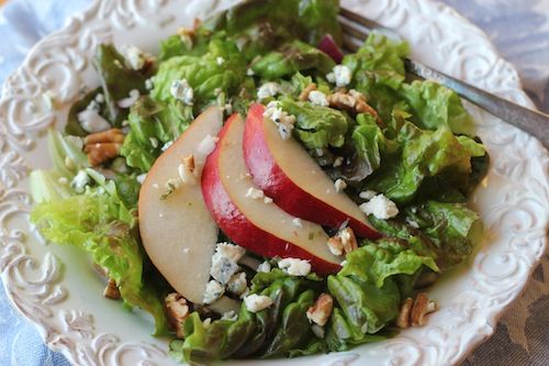 a salad with apples and blue cheese on it