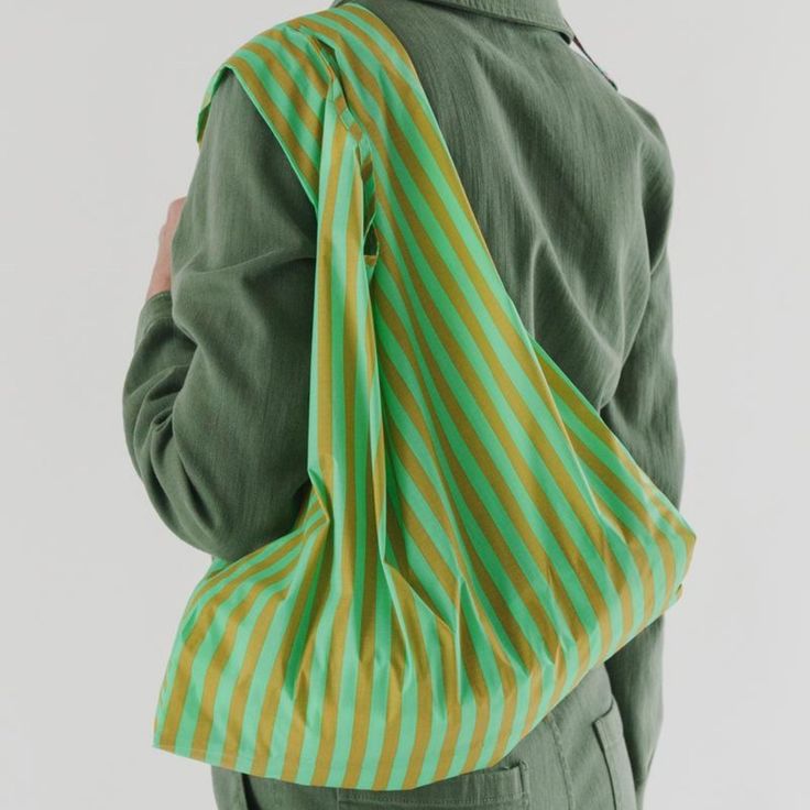 a person wearing a green and yellow striped bag