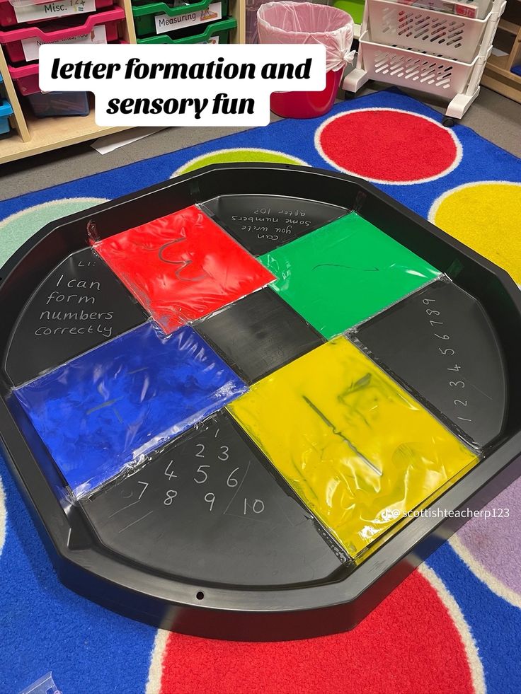 a black tray with different colored squares on it and the words letter formation and sensory fun