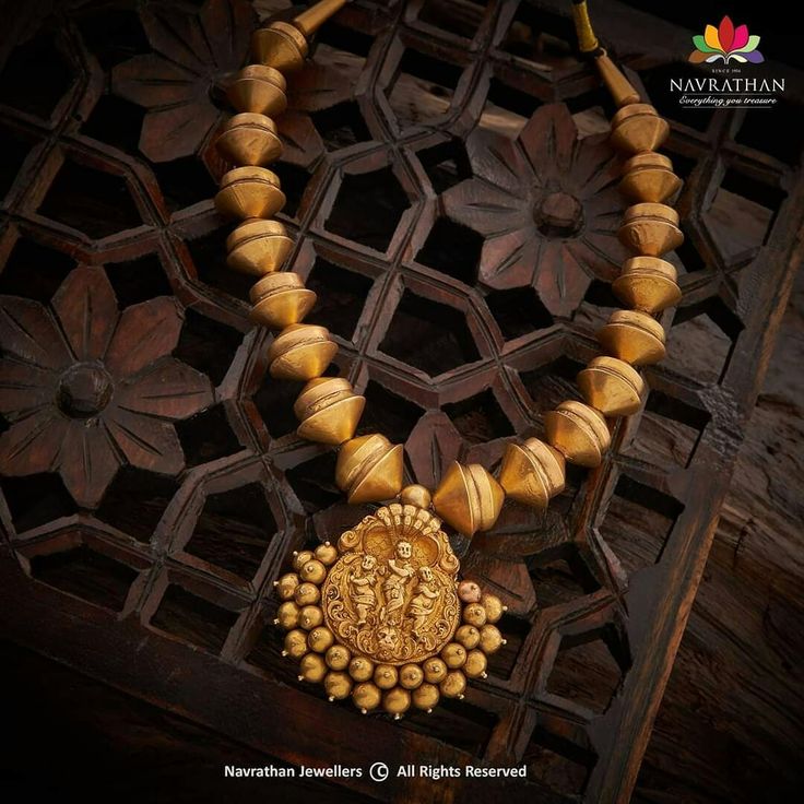 Krishna Pendant with Mangalore Design Beads: A custom-made necklace inspired by antique temple jewellery styles and fused to global styling in jewellery making. It gleams divine radiance and is charmingly hand crafted in lavish and rich gold. Step into our stores and enliven yourself with its delights or visit us at www.navrathan.com and get your hands on it faster!  #Jewellery #Navrathan #Jewellers #Gold #Silver #Diamond #GoldNecklaceDesign #SilverArticles #PlatinumJewellery #TempleJewellery Handmade Brass Temple Necklace, Antique Temple Jewellery, Brass Tilla Temple Necklace For Wedding, Elegant Brass Temple Necklace With Tilla, Luxury Brass Temple Necklace, Navrathan Jewellers, Krishna Pendant, Traditional Brass Temple Necklace, Luxury, Temple Jewellery Earrings