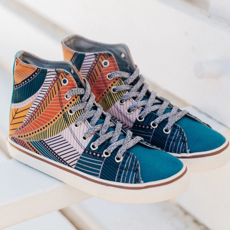 a pair of colorful shoes sitting on top of a white bench