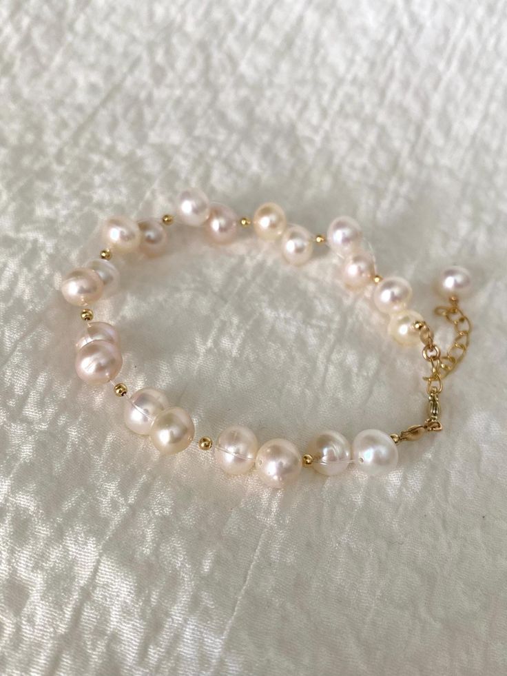 ✨ Welcome to The Pearly Loft ✨ Introducing 💖 Ariel 💖 - our stunning Freshwater Pearl Bracelet featuring an elegant Irregular Pearl design with 14K Gold Filled components. This Baroque Pearl Bracelet is perfect as a Bride Bracelet or a beautiful addition to your Minimalistic Jewelry collection. The Delicate Bracelet design is ideal for those who appreciate understated elegance and Boho Wrislet style. Handcrafted with care, Ariel showcases the natural beauty of Real Pearl Bracelet with its unique irregular pearls. The 14K Gold Filled accents add a touch of luxury, making this Elegant Bracelet a standout piece for any occasion. Whether you're looking for a versatile Everyday Bracelet or a Cute Wristlet to complement your outfit, Ariel is designed to impress. ✨ Details: - 6" inches + 2" inch Handmade Cute Pearl Bracelet, Elegant Hand-strung Charm Bracelet, Hand-strung Pearl Bracelet Gift, Elegant Hand-strung Charm Bracelet Gift, Elegant Gold Hypoallergenic Rosary Bracelet, Hand-strung Pearl Bracelet, Elegant Hypoallergenic Gold Rosary Bracelet, Elegant Hypoallergenic Rosary Bracelet, Elegant Handmade Gold Rosary Bracelet