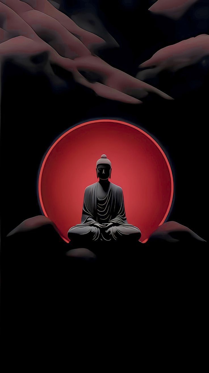 a buddha statue sitting on top of a red bowl in the middle of a dark room