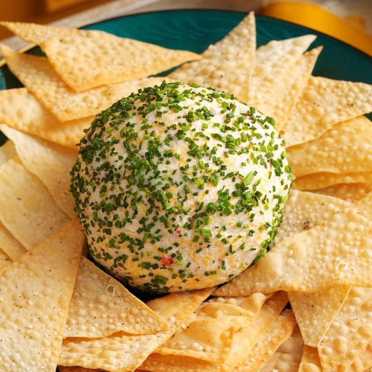 a cheese ball with sprinkles on it surrounded by tortilla chips