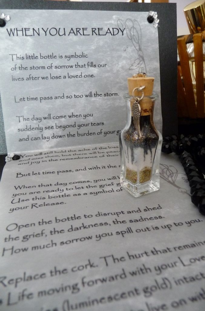 a message in a glass bottle sitting on top of a table next to a note