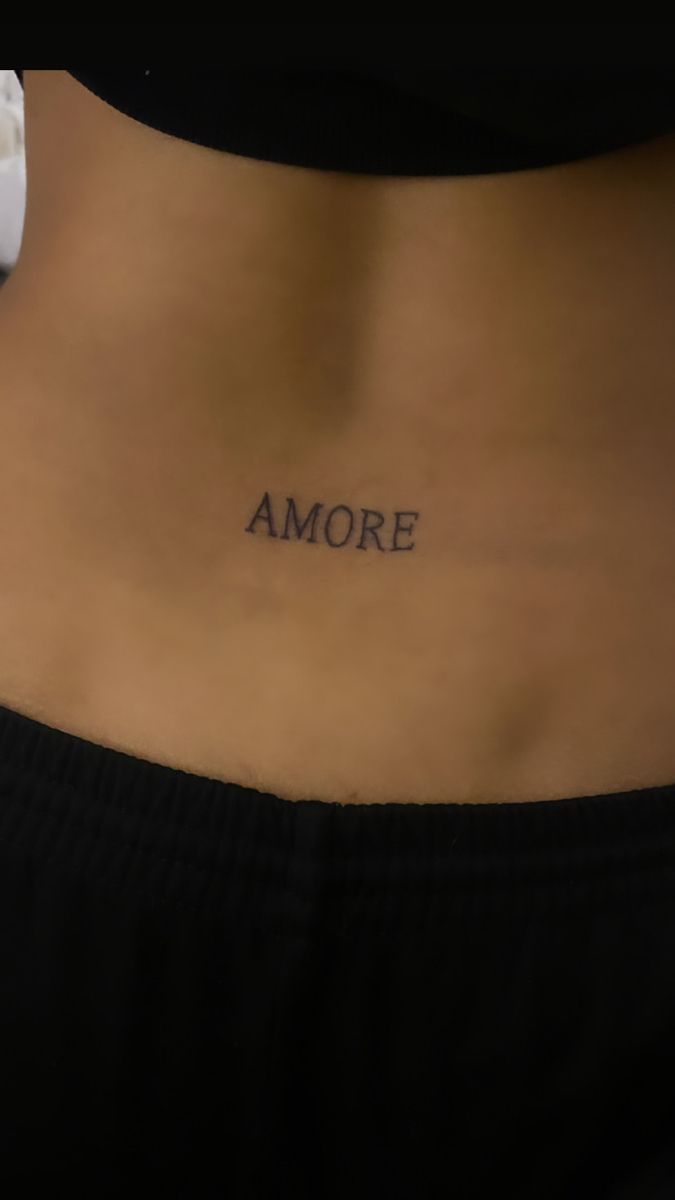 a woman's stomach with the word amore written on it