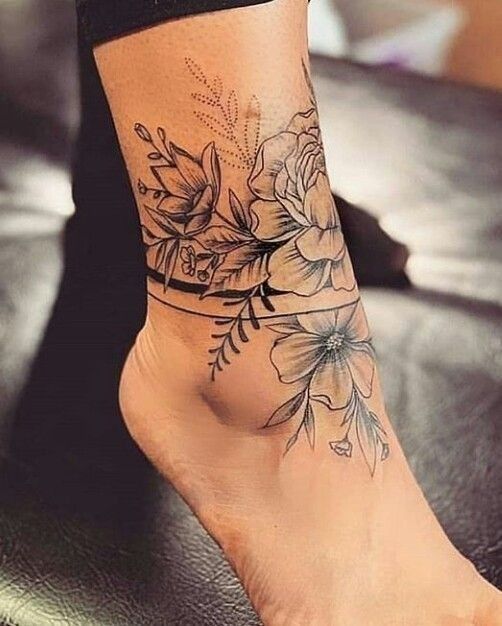 a woman's foot with flowers on it