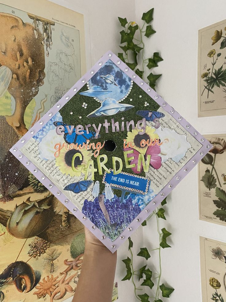 someone holding up a graduation cap that says everything is going to the garden on it