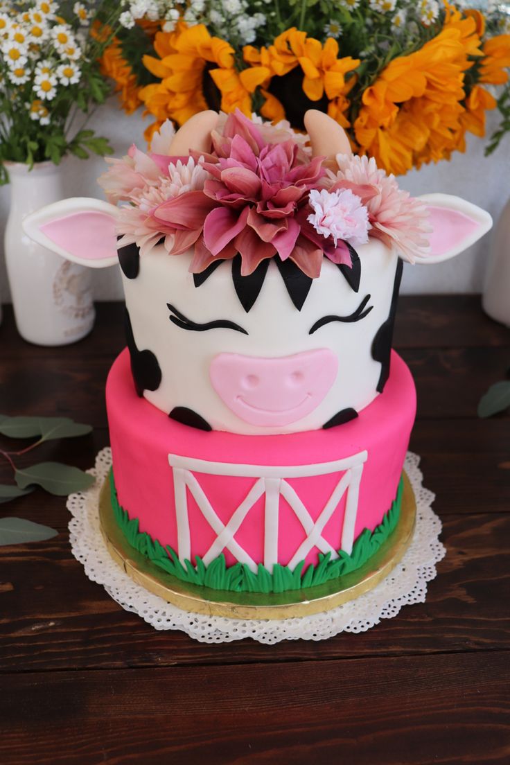 a cake decorated with flowers and a cow