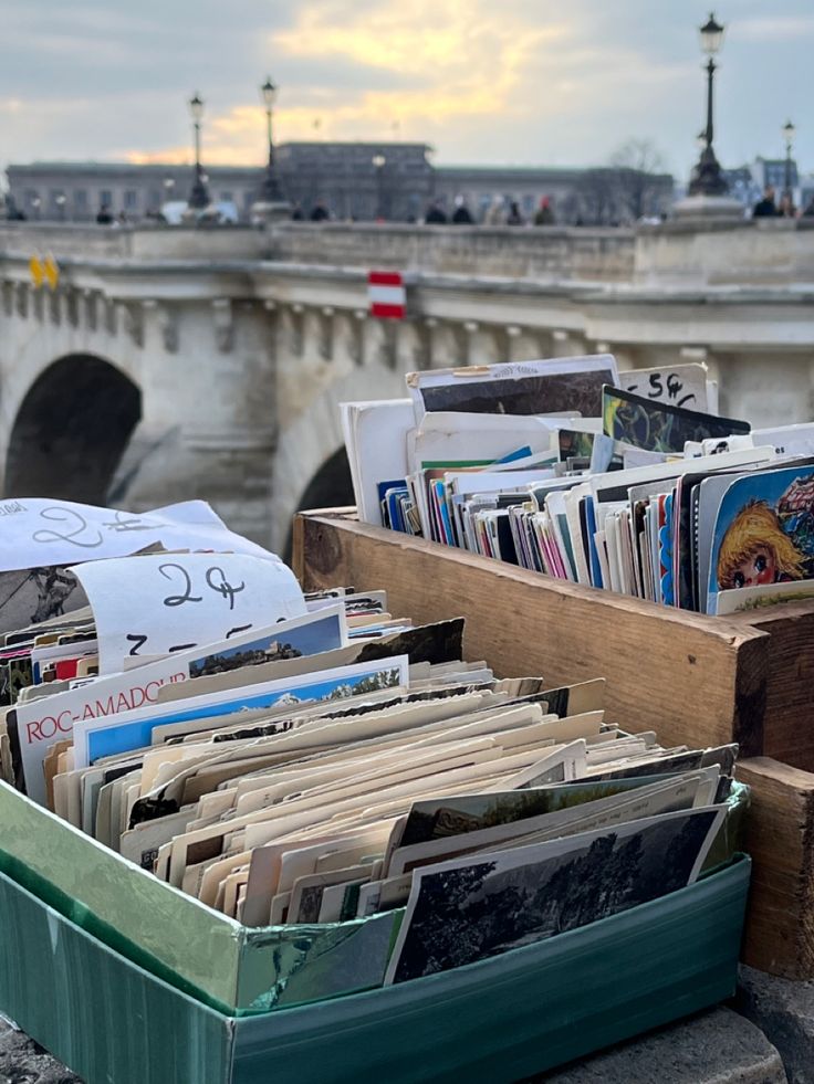 an old box full of records in front of a bridge