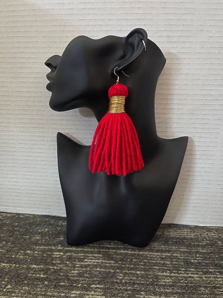 Beautiful handmade full red tassel earrings! These can be worn everyday and will compliment any look for any occasion! Gold wire wrapped around the tassel for a fresh look! These are light weight! Red tassels will make you feel confident! Length can be personalized as well as the fish hook (silver/gold/plastic)