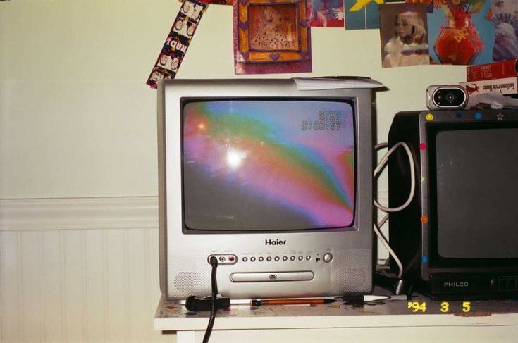 an old television sitting on top of a shelf