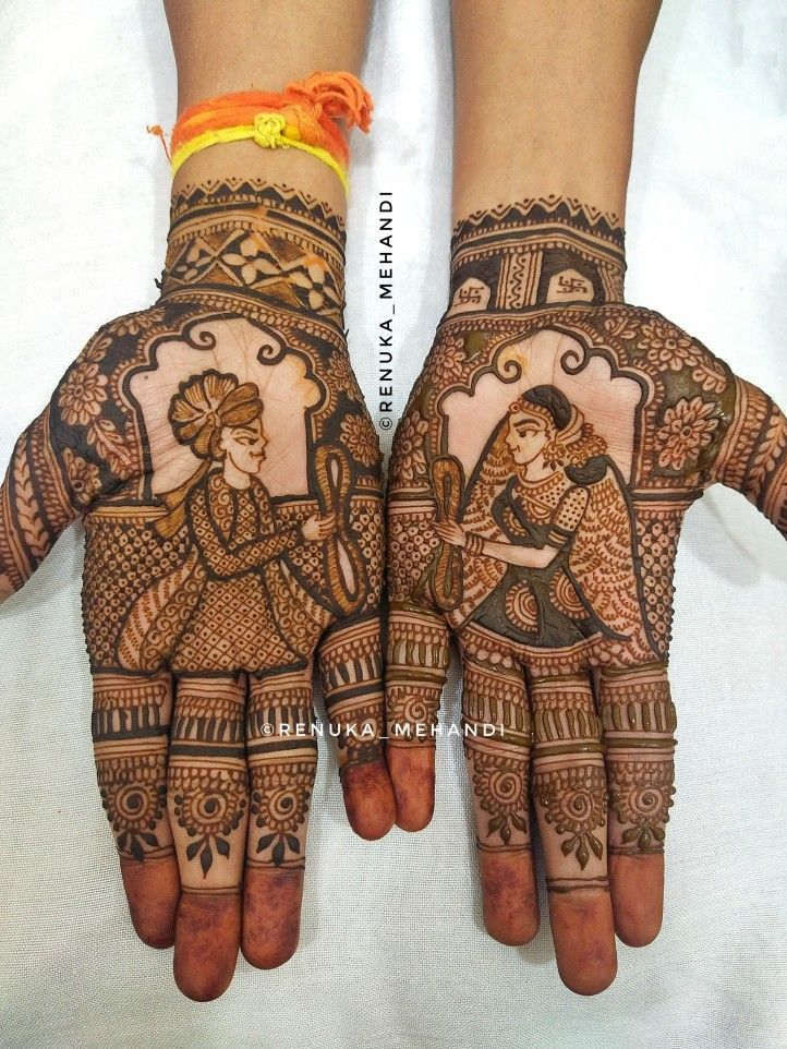 two hands with henna designs on them