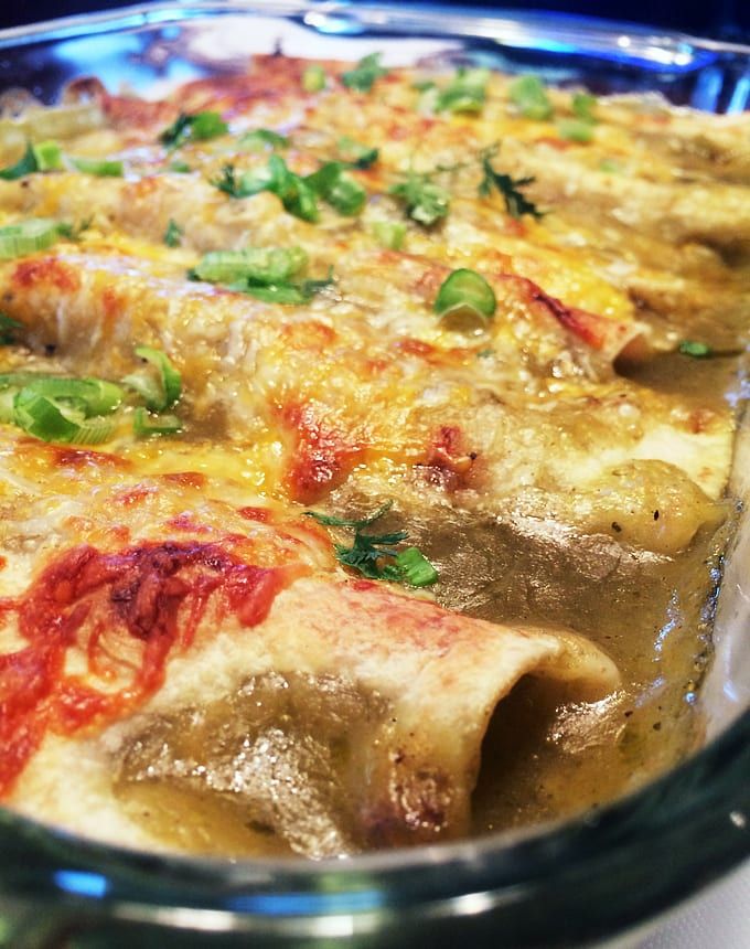 a casserole dish with meat, cheese and vegetables in it sitting on a table