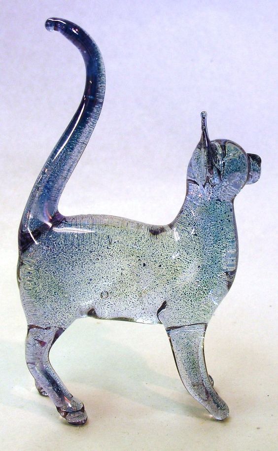 a glass figurine of a cat on a white background