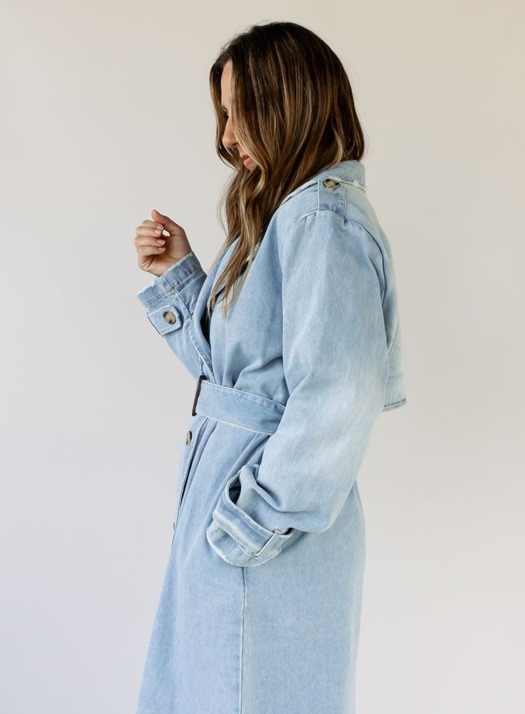 double breasted denim midi trench coat button front closure removable belt pockets long sleeves midweight unlined no stretch 100% rayon hand wash cold Katie is 5’7” wearing size medium small: 46" bust // 46.5" length medium: 49" bust // 47" length large: 52" bust // 47.5" length Spring Washed Collared Outerwear, Double-breasted Denim Outerwear With Button Closure, Button-up Medium Wash Outerwear For Day Out, Medium Wash Button-up Outerwear For Day Out, Chic Dark Wash Button-up Outerwear, Spring Light Wash Relaxed Fit Outerwear, Spring Light Wash Relaxed Outerwear, Light Wash Relaxed Fit Outerwear For Spring, Trendy Light Wash Collared Outerwear