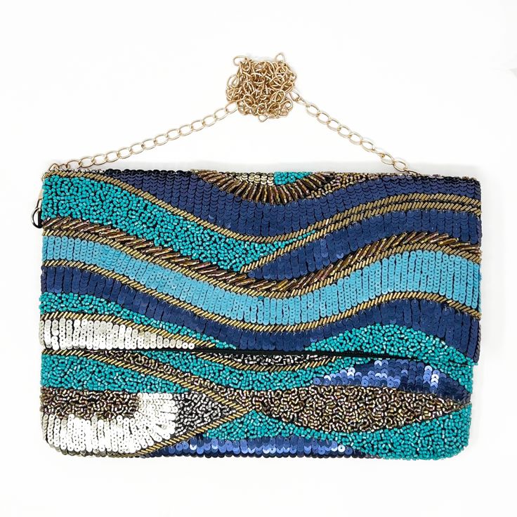 There's no chance you'll experience the blues when you're carrying this clutch. It reminds us of the waves of the ocean and no one has the blues staring at the beach 😎 12 in x 8 in Blue & Gold bead & sequin embellishments Black canvas backing and lining Embellished Blue Party Clutch, Blue Embellished Party Clutch, Blue Beaded Clutch Bag, Blue Embellished Rectangular Clutch, Blue Beaded Clutch Evening Bag, Rectangular Blue Beaded Clutch, Blue Beaded Evening Bag For Party, Blue Beaded Party Bag, Blue Sequin Evening Bags