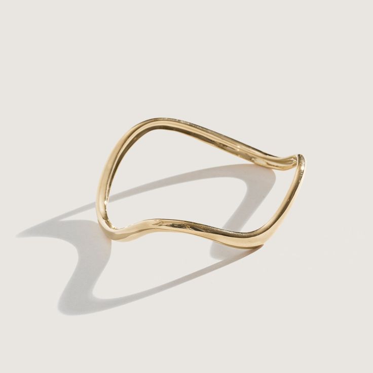 The Ophelia collection is inspired by my Nanny Ophelia, who first introduced me to jewelry. Each bangle has subtle movement to add something special to a classic everyday bangle. Available in 14K Gold Plate over Brass and Sterling Silver Approximately 0.22" Width Small circumference approximately 2.4" Medium circumference approximately 2.5" Large circumference approximately 2.6" Handmade in NYC In stock items ship in 1 - 4 days Elegant Yellow Gold Brass Cuff Bracelet, Elegant Brass Bracelets With Polished Finish, Elegant Brass Bracelet With Polished Finish, Elegant Gold Bracelet With Open Band, Elegant Gold Open Band Bangle, Gold Open Band Bangle Gift, Elegant Open Band Bangle With Polished Finish, Adjustable 14k Gold Bangle, Fine Jewelry, Minimalist Yellow Gold Brass Cuff Bracelet