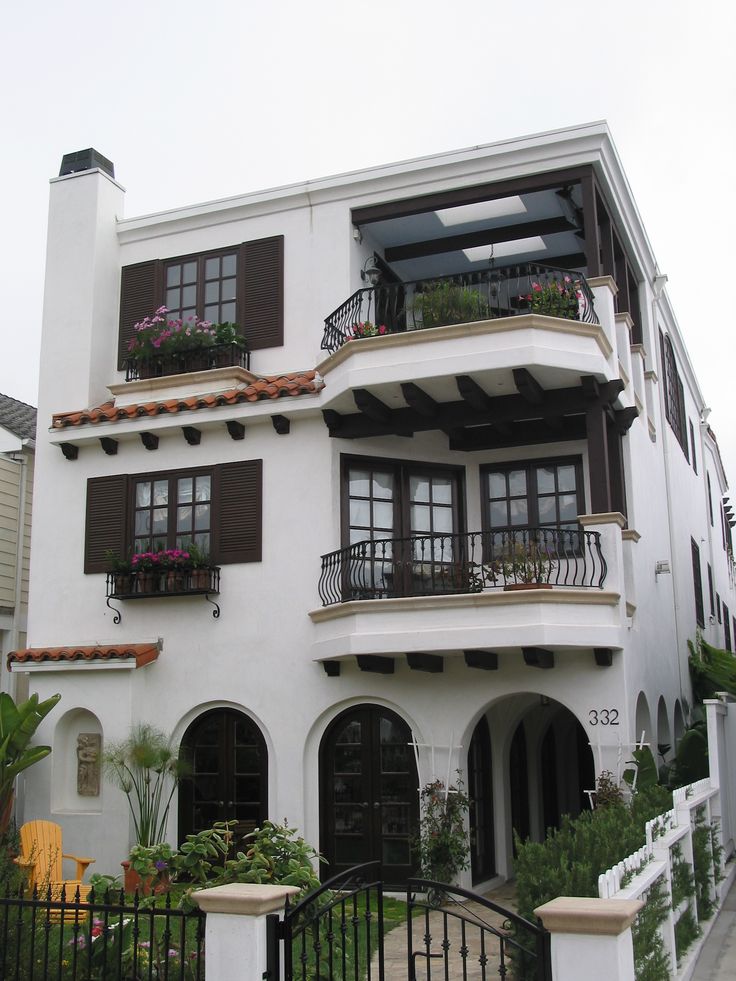 a large white building with lots of windows and balconies