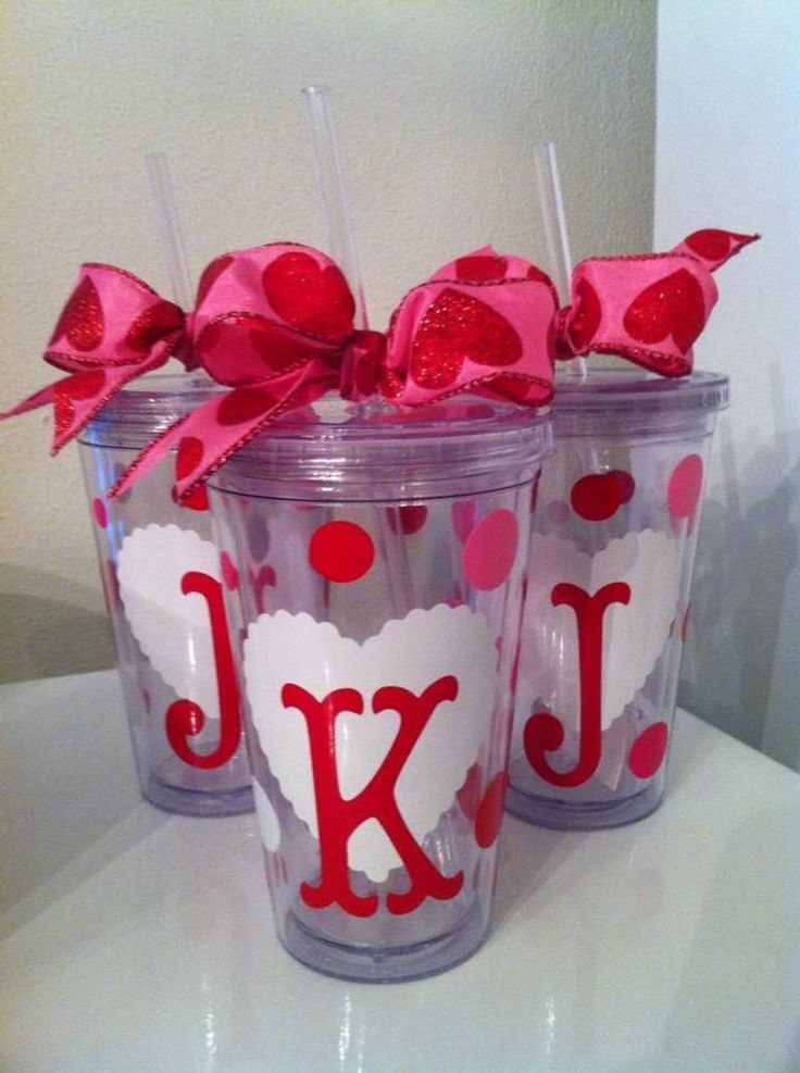 three personalized tumblers with red bows and polka dot designs on them are sitting on a counter