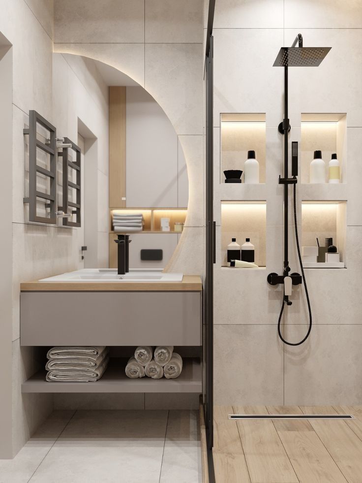 a bathroom with a sink, mirror and shower head mounted to the side of it