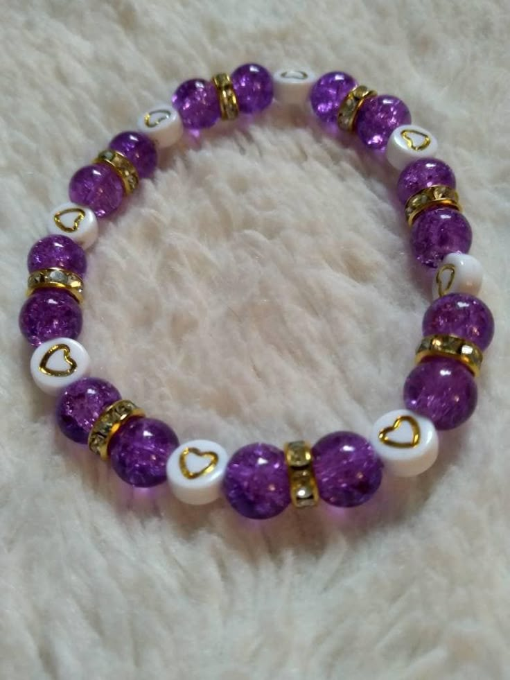 a purple and white beaded bracelet with hearts