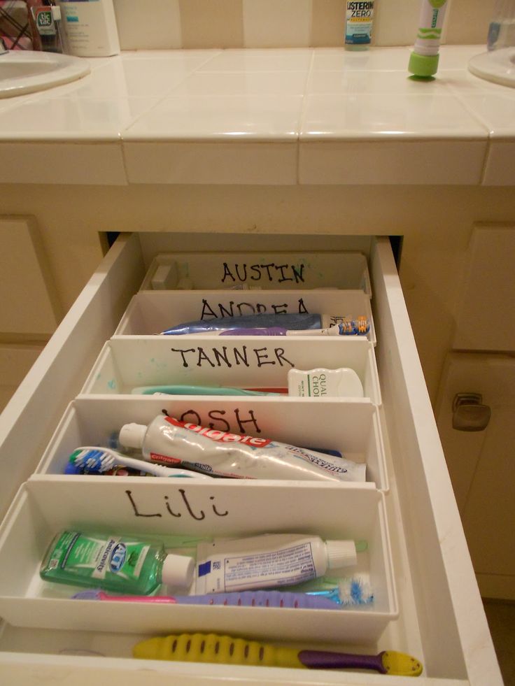 an open drawer containing toothbrushes and other hygiene products