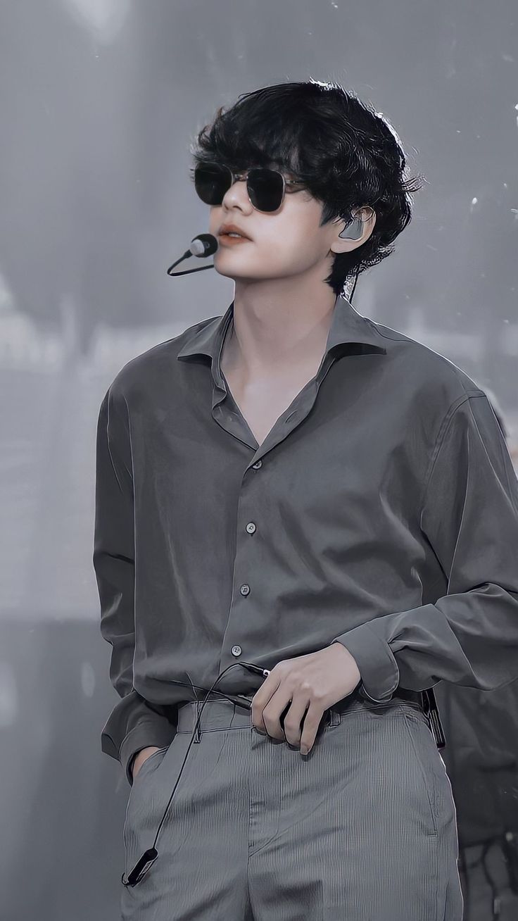 a man with black hair and sunglasses on his face