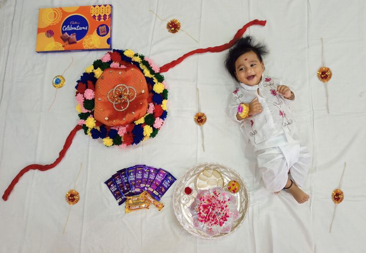 a baby laying on the floor next to some decorations