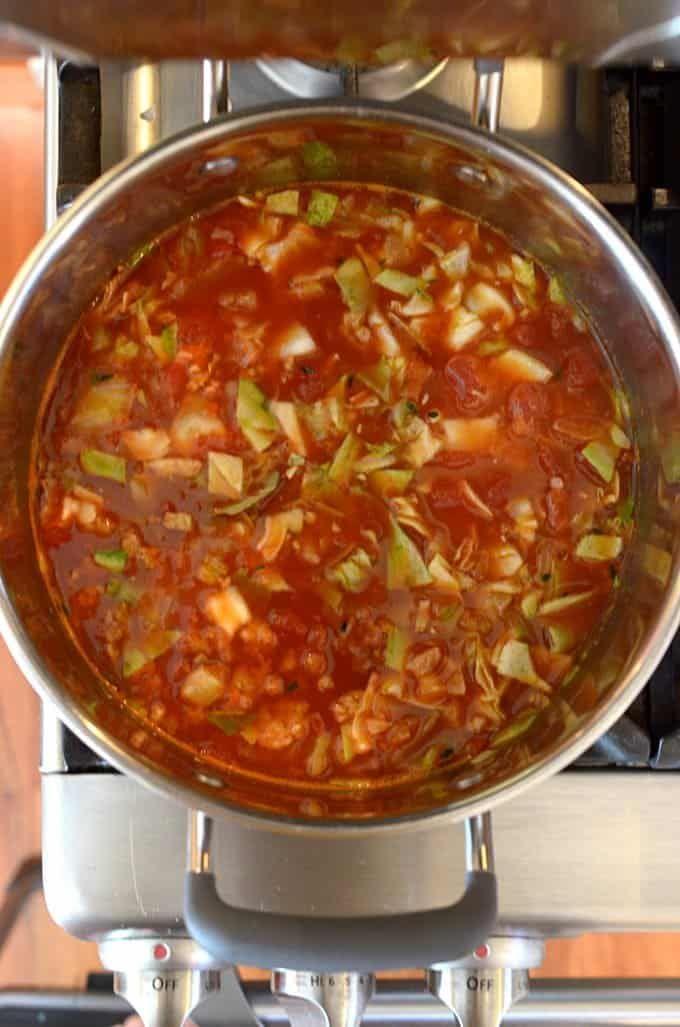 a pot full of food sitting on top of a stove