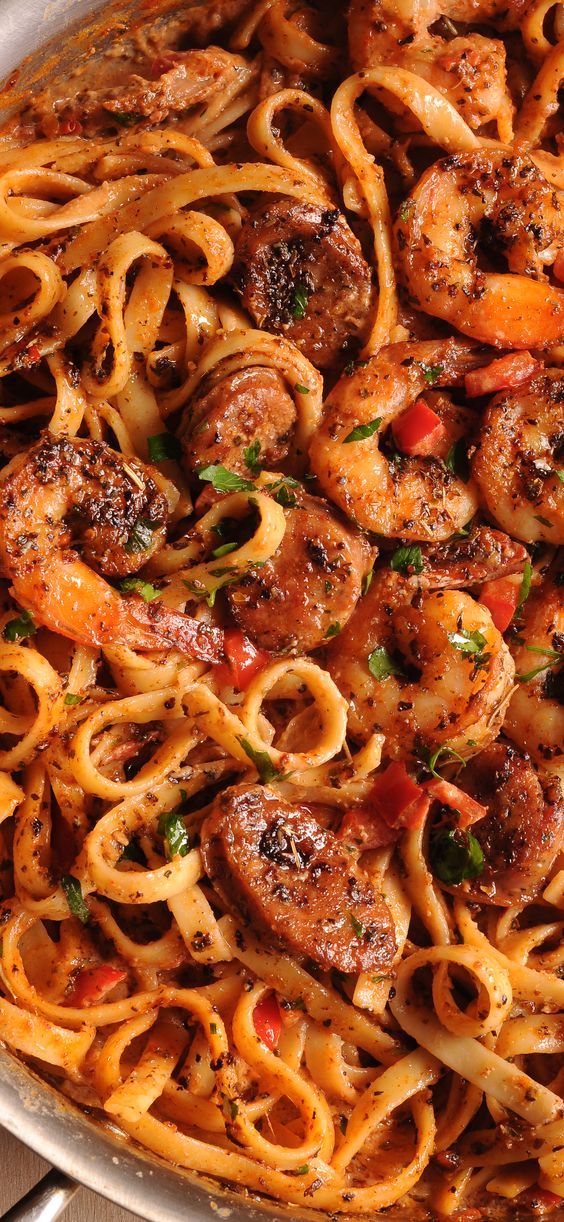 pasta with shrimp and tomato sauce in a pan