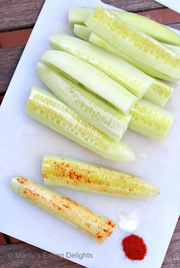 several pieces of celery sitting on top of a cutting board next to seasoning