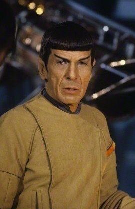 a star trek spock is holding something in his hand