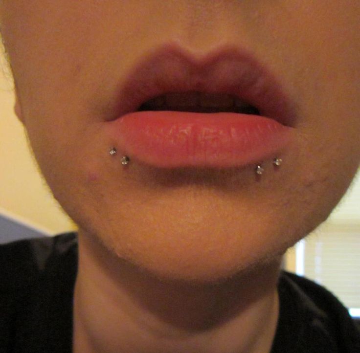 a woman with piercings on her tongue