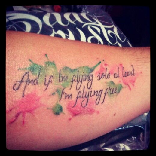 a woman's arm with the words and flowers on it