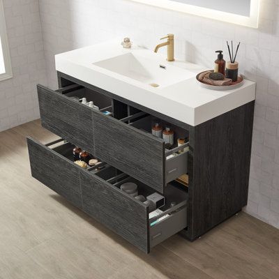 a bathroom vanity with two drawers and a sink in the middle, next to a mirror