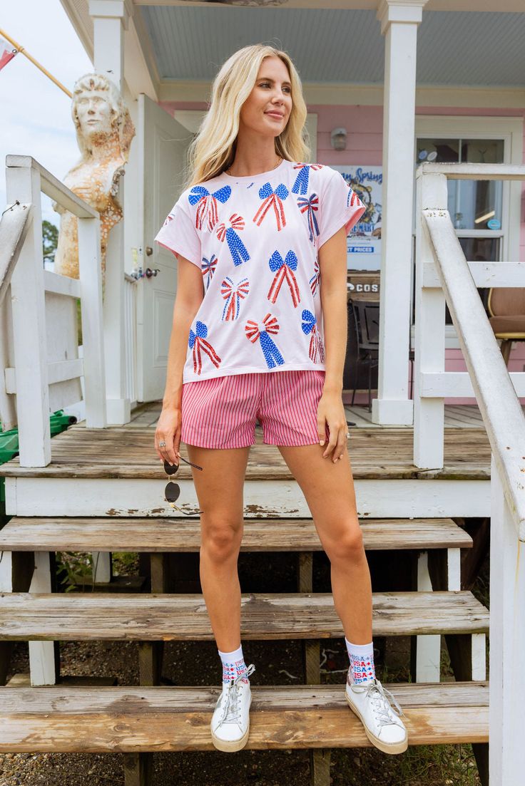 Add some patriotic flair to your wardrobe! Meet our classic tee, complete with a sequin American-themed bow design. 🎀🇺🇸 Model is wearing an xs! Care Instructions: hand wash only, inside out, in cold water Queen Summer, Rodeo Queen, Queen Mother, Fall Kids, Bow Design, Dancing Queen, Romper Pants, Cover Up Dress, Favorite Child