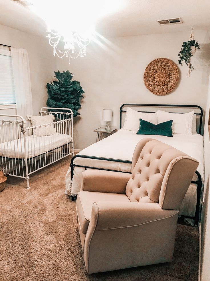 a baby's room with two cribs, a bed and a chair