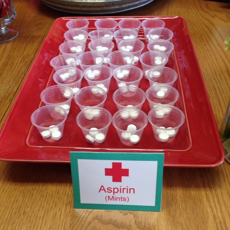 a red tray filled with cups on top of a wooden table