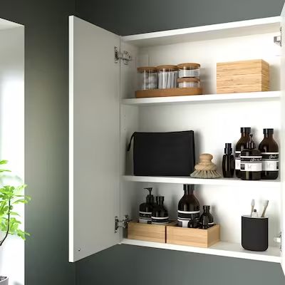 the shelves in the bathroom are filled with various items