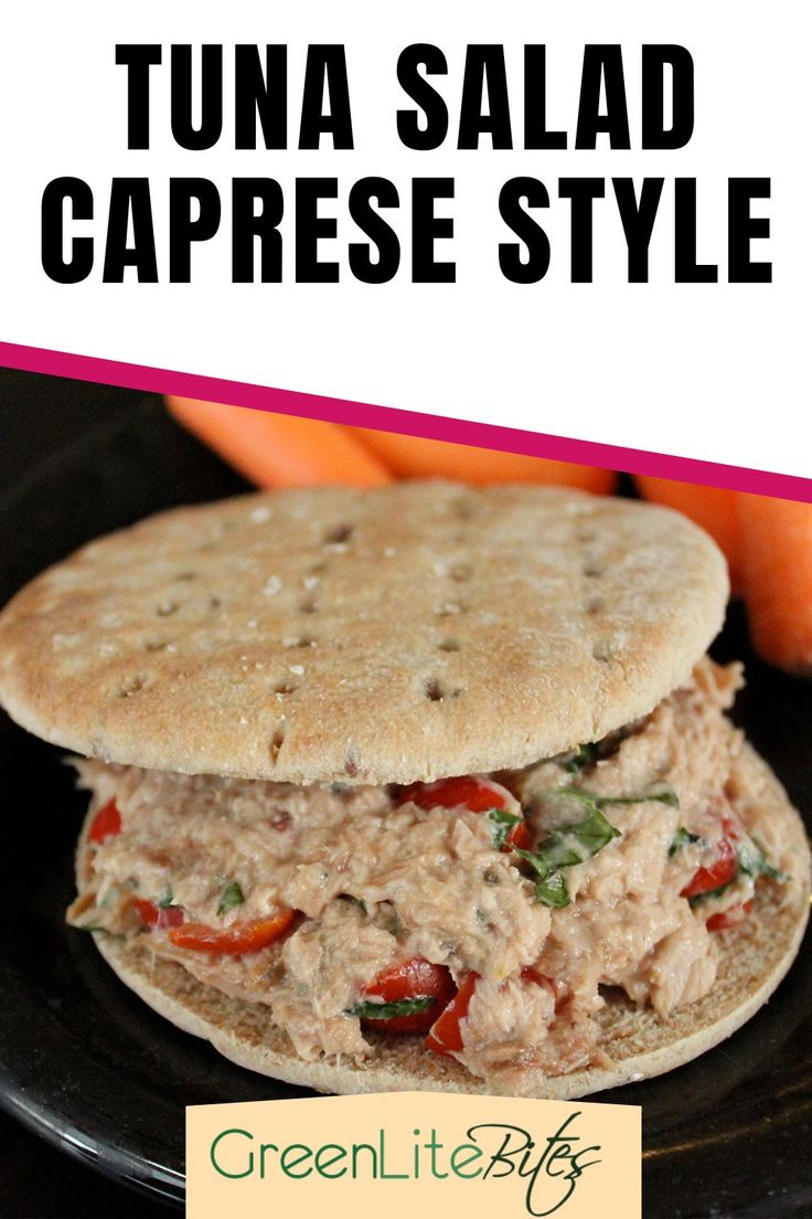 tuna salad caprese style on a black plate with carrots in the background