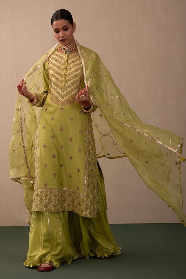 Lime green straight kurta with all over zari and gota embroidery. Paired with a sharara with zari embroidery and dupatta.
Components: 3
Pattern: Embroidery
Type Of Work: Zari, Gota
Neckline: Round Neck
Sleeve Type: Full Sleeves
Fabric: Silk Chanderi, Organic Cotton: Sharara, Organza: Dupatta 
Color: Green
Other Details: 
Dupatta with gota embroidery
Occasion: Sangeet - Aza Fashions Semi-stitched Pista Green Sharara With Dabka Work, Unstitched Pista Green Sharara With Dabka Work, Pista Green Semi-stitched Sharara With Dabka Work, Pista Green Sharara With Resham Embroidery For Eid, Fitted Green Unstitched Suit In Dola Silk, Green Dola Silk Dress Shaped As Straight Kurta, Eid Pista Green Sharara With Resham Embroidery, Fitted Green Dola Silk Kurta, Green Dola Silk Kurta With Dupatta