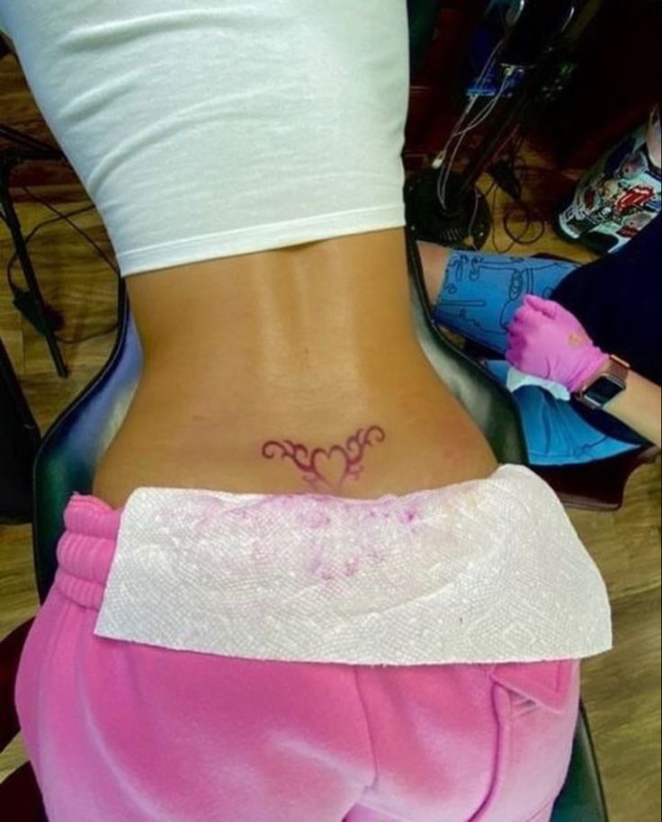 a woman with a tattoo on her lower back