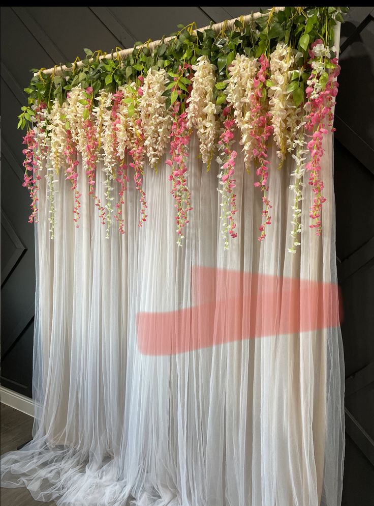 the curtain is decorated with pink and white flowers on it's side, along with greenery