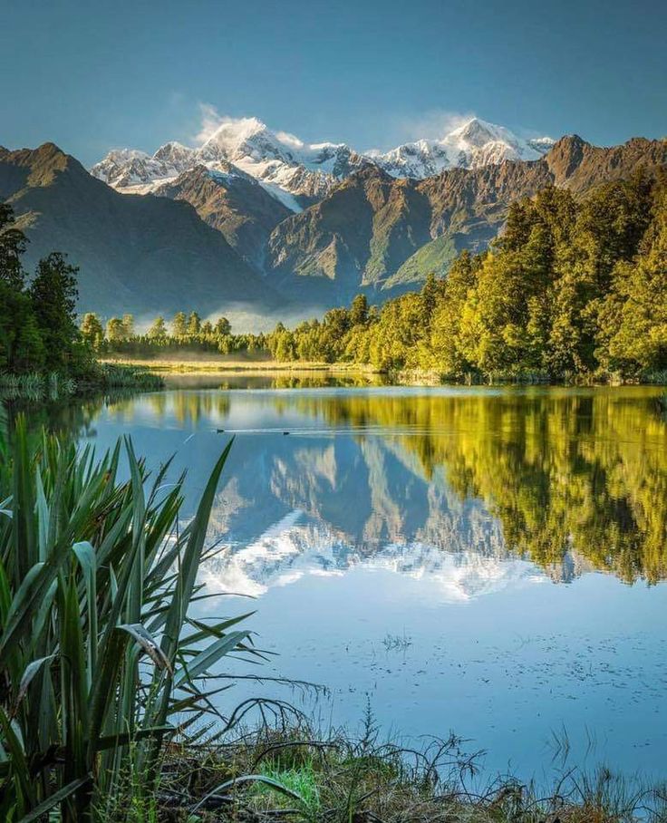 a lake surrounded by mountains and trees