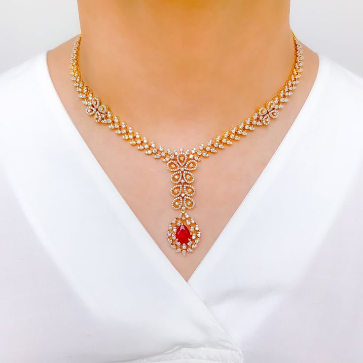 Make a statement with this Intricate Floral Ruby Diamond Set. Crafted from 18k yellow gold, this set features sparkling diamonds with a total weight of 8.34 carats, and exquisite pear-shaped rubies. The interchangeable stones allow for versatility, while the 16.75" set length and 2.25" drop length provide a striking look. Matching screw-back earrings complete the set. PRODUCT DETAILS Gold Purity(karat): 18k Item Weight(grams): 62.8 Item Finish: Yellow Gold Stone: Diamond Diamond Weight(carats): Luxury Ruby Diamond Necklace With Diamond Accents, Luxury Ruby Diamond Necklace With Accents, Elegant Ruby Jewelry Sets For Reception, Formal Ruby Diamond Necklace With Brilliant Cut, Formal Bridal Necklace In Yellow Gold With Gemstone, Elegant Gold Necklace With Ruby, Luxury Red Ruby Diamond Necklace, Formal Red Diamond Necklace With 17 Jewels, Formal Yellow Gold Bridal Necklace With Gemstone