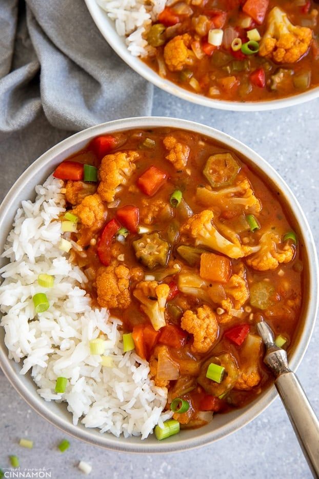 two bowls filled with stew and white rice