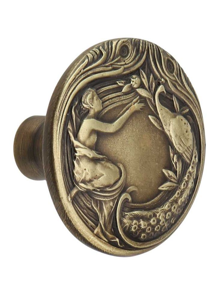 an antique style door knob with a mermaid on it