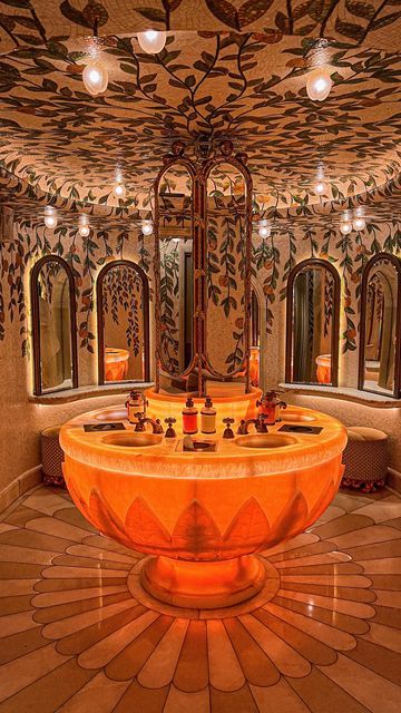 a fancy bathroom with an orange sink in the center